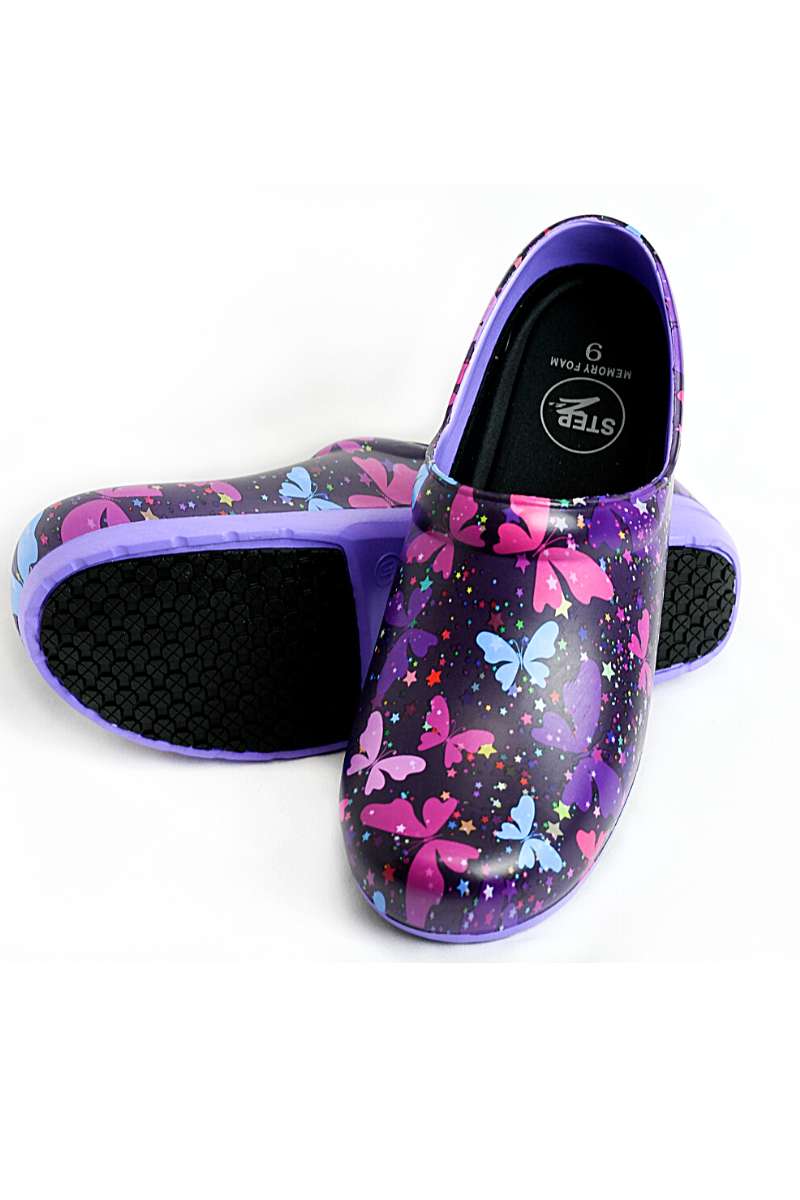 A view of the bottom & front of the StepZ Women's Slip Resistant Memory Foam Clog in "Celestial Butterflies" size 7 featuring a classic slip-on style & a heel height of roughly 1.5".