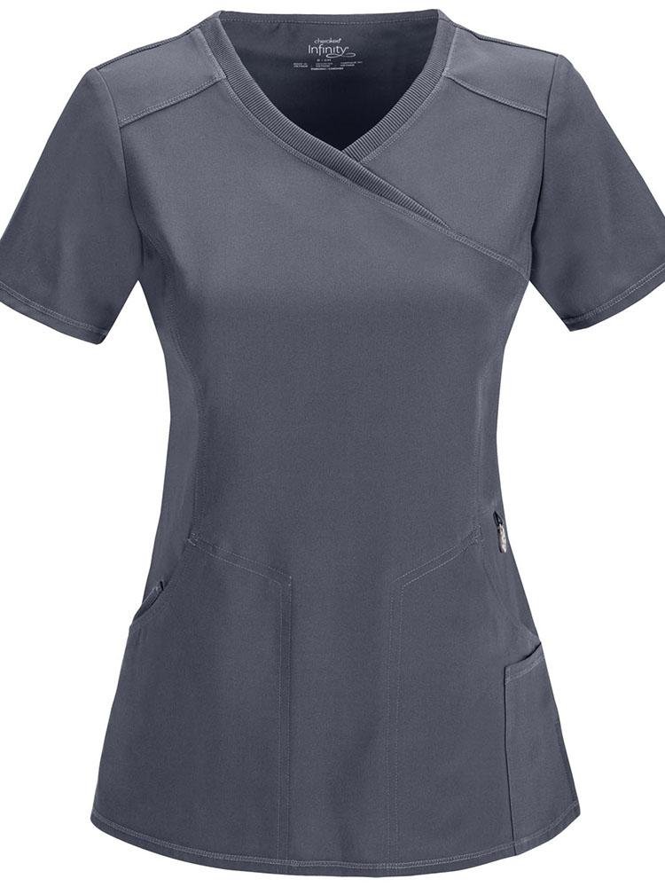 A frontward facing image of the Cherokee Infinity Women's Antimicrobial Mock Wrap Top in pewter size small featuring a stretch back panel for extra movement & comfort.