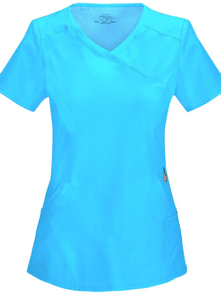 A frontward facing image of the Cherokee Infinity Women's Antimicrobial Mock Wrap Top in turquoise size XS featuring a logo O-ring above left pocket.