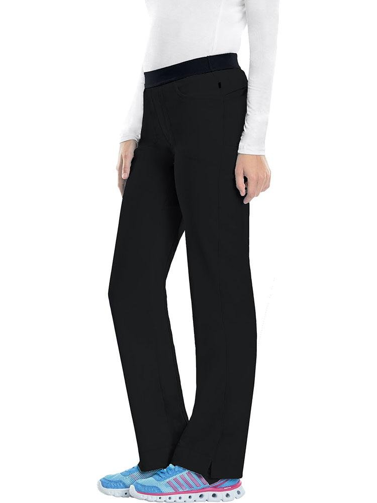 A young female Phlebotomist wearing a Cherokee Infinity Women's Low-Rise Slim Pull On Scrub Pant in black size Medium featuring an elastic waistband.