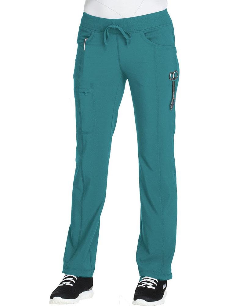 A female Dental Assistant wearing a Cherokee Infinity Women's Low-Rise Straight Leg Scrub Pant in teal featuring availability in plus sizes.