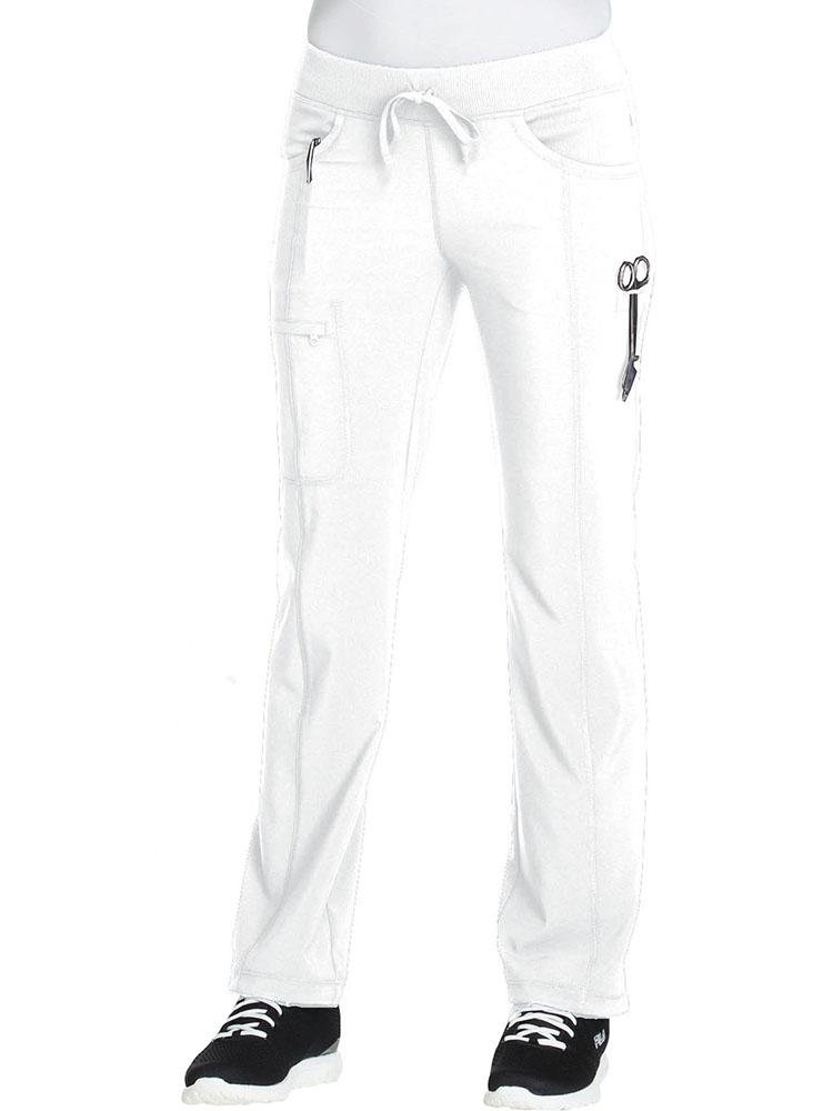A young Physical Therapist wearing a Cherokee Infinity Women's Low-Rise Straight Leg Scrub Pant in white featuring front leg seams & a zip closure cargo pocket.