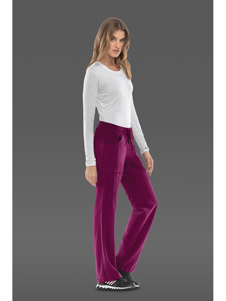 A female Radiologic Technologist wearing a pair Cherokee Infinity Women's Low-Rise Straight Leg Scrub Pant in wine size medium featuring a comfortable stretch poplin fabric.