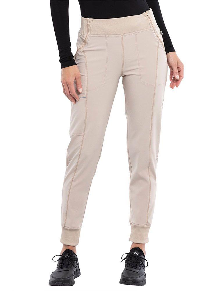 Cherokee Infinity Women's Mid Rise Tapered Jogger in khaki featuring front angled zipper pockets