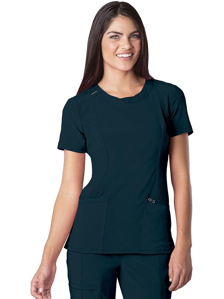 A female Phlebotomist wearing a Cherokee Infinity Women's Round Neck Scrub Top in Caribbean size XS featuring a stretch rib knit back panel for added movement.
