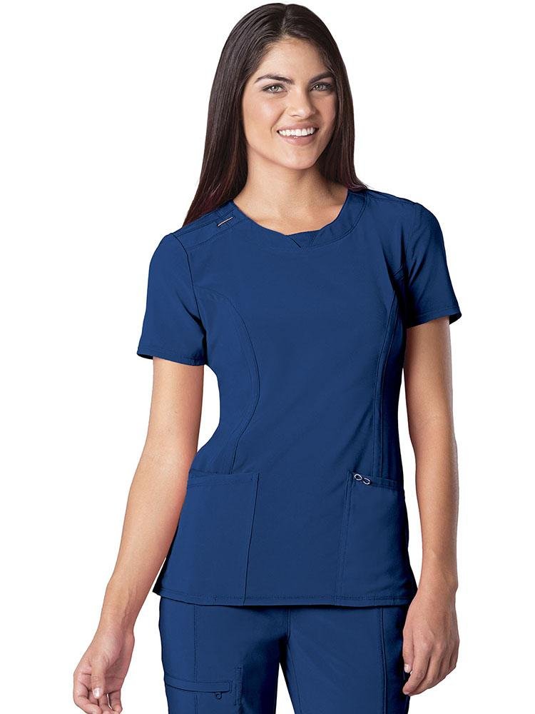 A young female LPN wearing a Cherokee Infinity Women's Round Neck Scrub Top in Royal size Medium featuring Antimicrobial easy care fabric.
