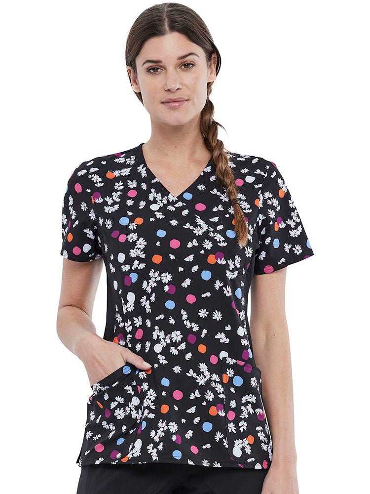 Young woman wearing a Women's Knit Panel Print Top from Cherokee in Polka Dot Petals.