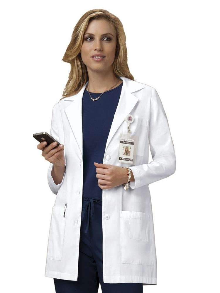 A young female Nurse Anesthesiologist wearing a Cherokee Women's Modern Classic 32" Lab Coat in white size extra small featuring 2 front patch pockets. 