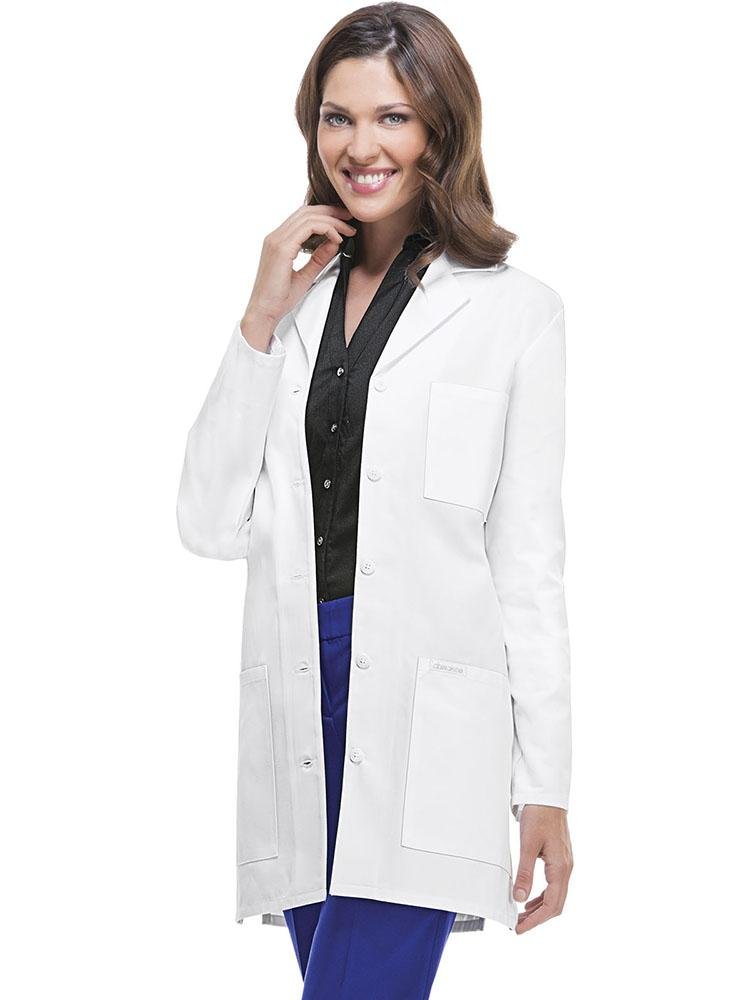 A young female Forensic Scientist wearing a Cherokee Women's Traditional 32" Lab Coat in White size Medium featuring a notched lapel for a professional looking all-day fit.