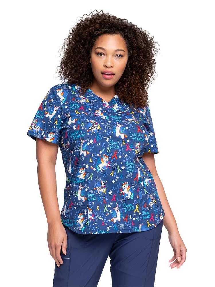 Young female healthcare professional wearing a Women's V-Neck Print Scrub Top from Cherokee in "Magical Care".
