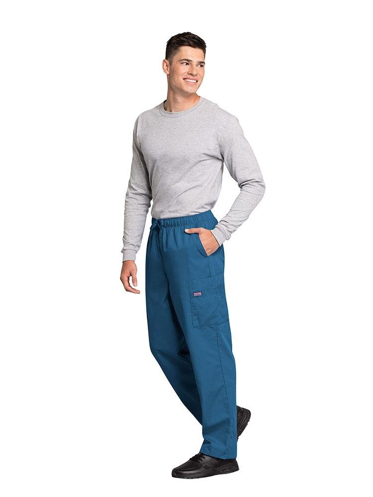 A male Sonographer wearing a Cherokee Workwear Originals Men's Drawstring Cargo Scrub Pant in Caribbean size Large featuring 2 front slash pockets & a functional zip fly.