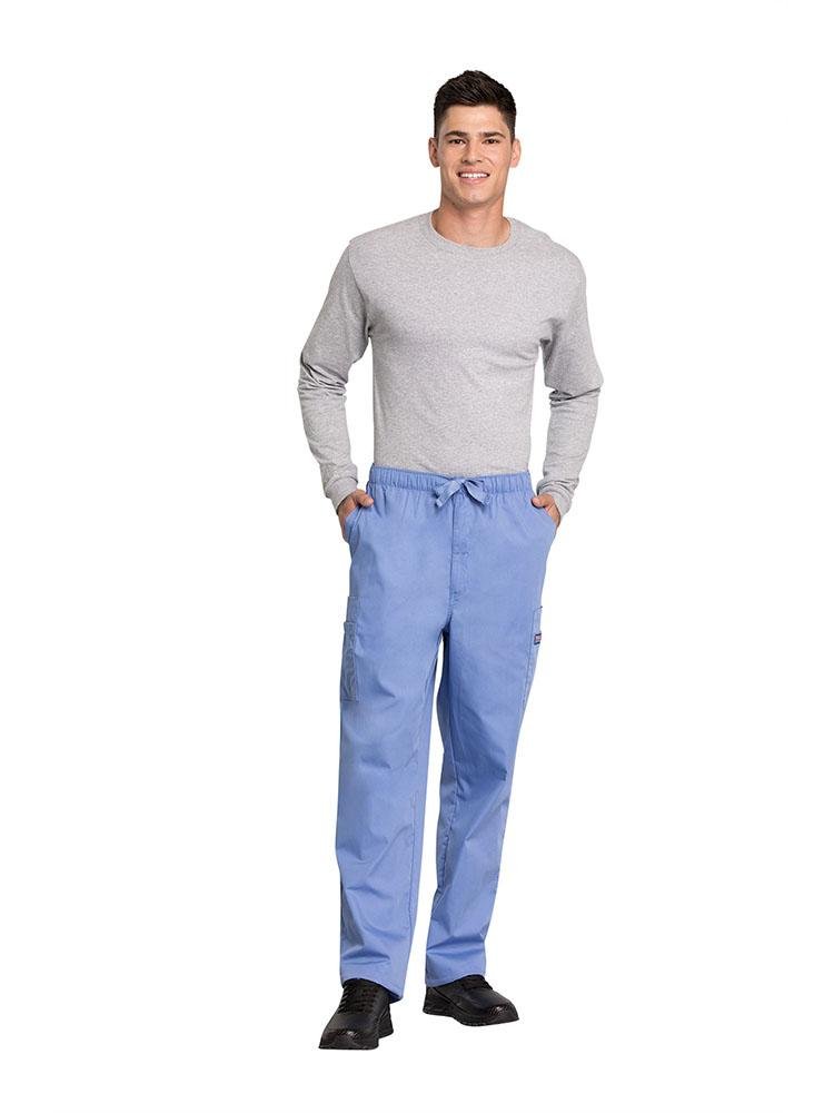 A young male Family Practitioner wearing a Cherokee Workwear Originals Men's Drawstring Cargo Scrub Pant in Ceil size 2XL featuring an elastic waistband with a webbed drawstring.