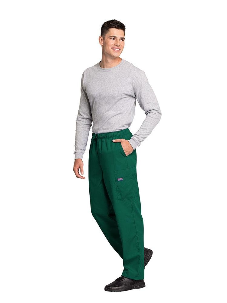 A male Respiratory Therapist wearing a Cherokee Workwear Originals Men's Drawstring Cargo Scrub Pant in Hunter size XL featuring 2 front slash pockets & a functional zip fly.