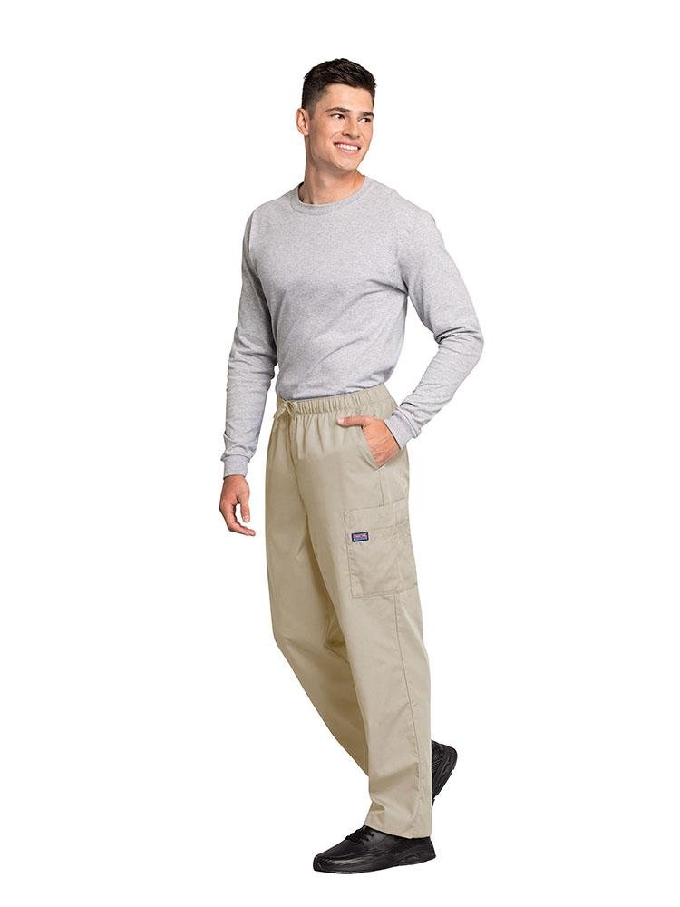 A male Physician's Assistant wearing a Cherokee Workwear Originals Men's Drawstring Cargo Scrub Pant in Khaki size 3XL featuring 2 front slash pockets & a functional zip fly.