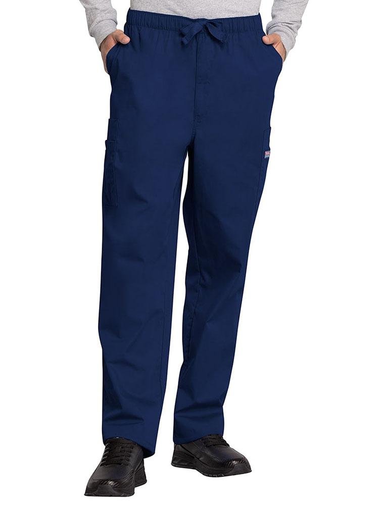 A young male Surgical Technologist wearing a Cherokee Workwear Originals Men's Drawstring Cargo Scrub Pant in Navy size Large featuring an elastic waistband with a webbed drawstring.