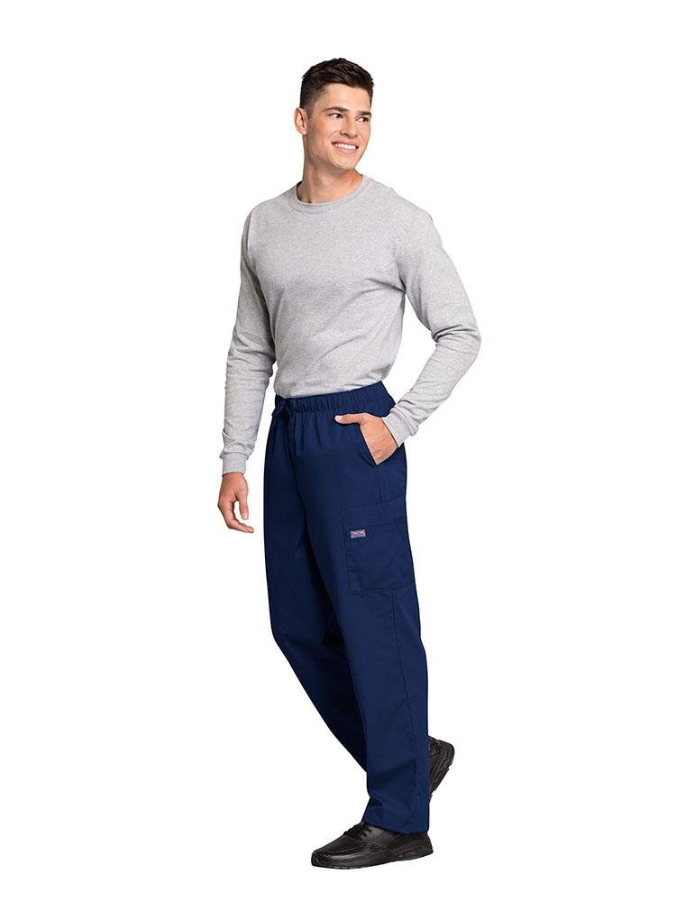 A male Psychiatric Aide wearing a Cherokee Workwear Originals Men's Drawstring Cargo Scrub Pant in Navy size XL featuring 2 front slash pockets & a functional zip fly.