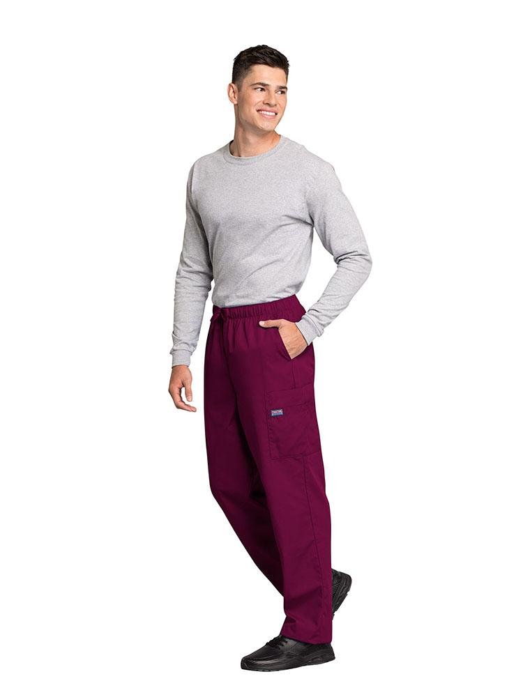 A male Psychiatric Aide wearing a Cherokee Workwear Originals Men's Drawstring Cargo Scrub Pant in Wine size Large featuring 2 front slash pockets & a functional zip fly.