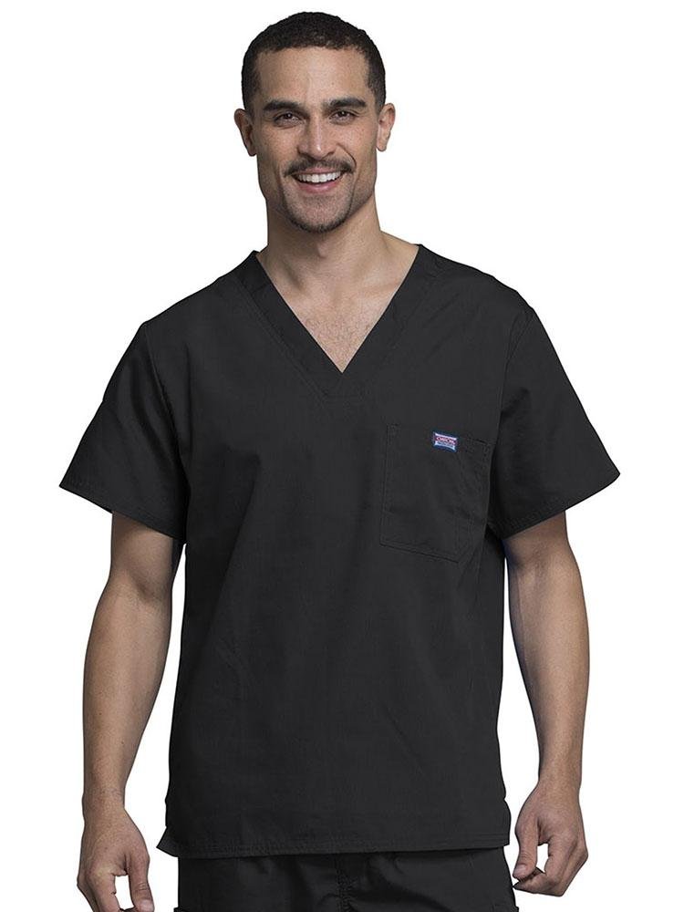 A young male Physician's Assistant wearing a  Cherokee Workwear Originals Men's Solid V-neck Scrub Top in Black size 3XL featuring a chests pocket with a pen slot on the wearer's left side.