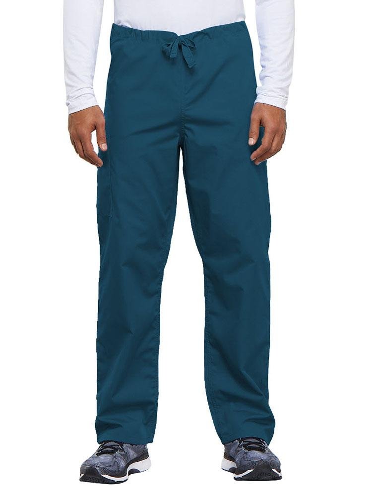 A young male Nurse Practitioner wearing a Cherokee Workwear Originals Unisex Drawstring Cargo Scrub Pant in Caribbean size Medium Short featuring a total of 3 pockets.