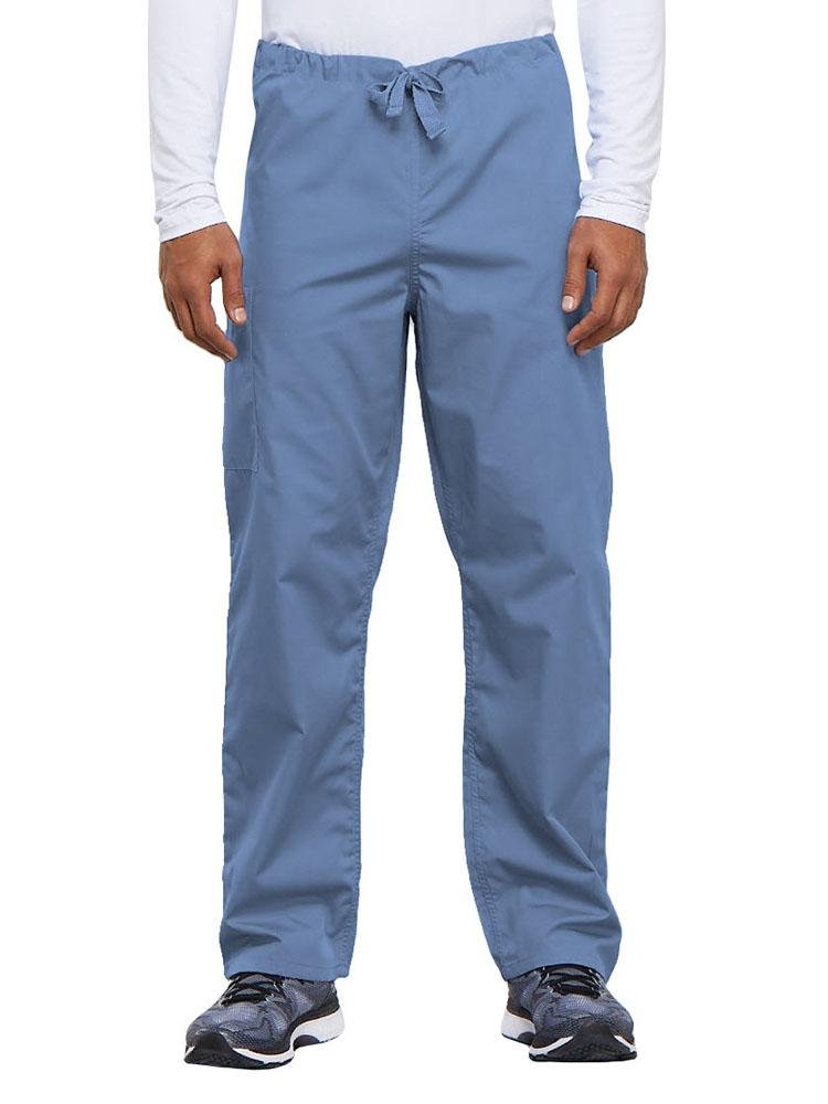 A young male Nurse Practitioner wearing a Cherokee Workwear Originals Unisex Drawstring Cargo Scrub Pant in Ceil size Medium Short featuring a total of 3 pockets.
