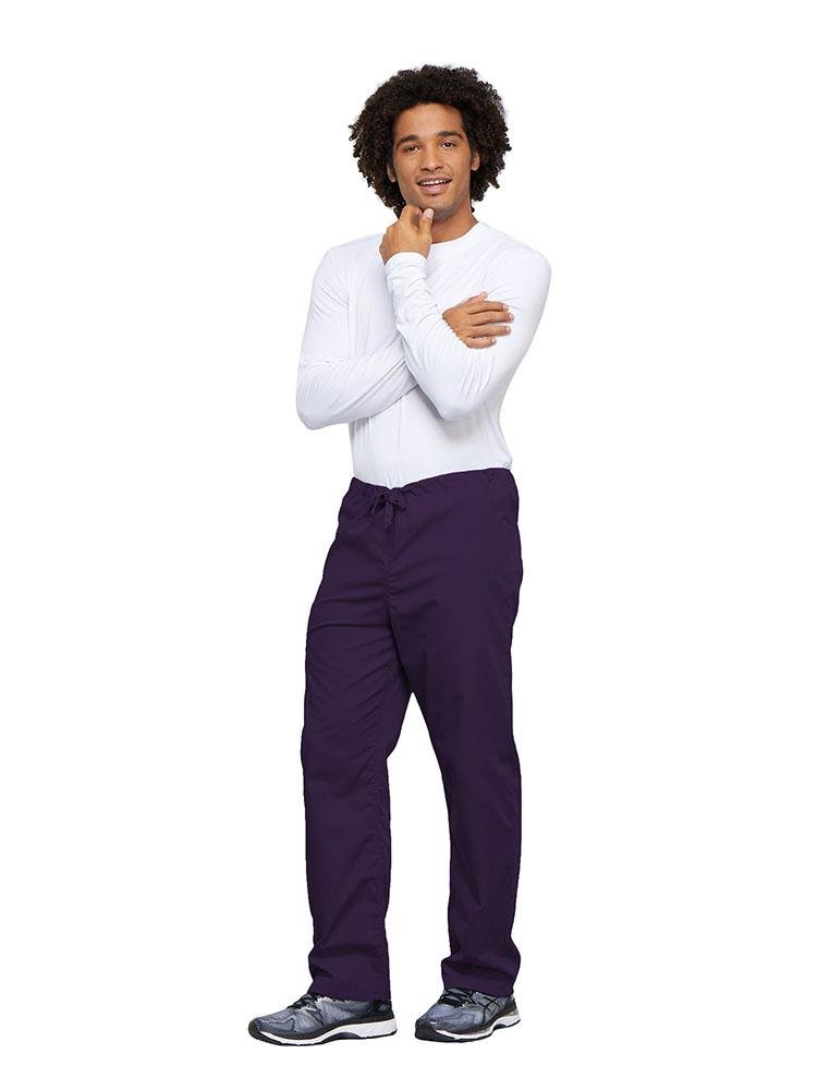 A young male Nurse wearing a Cherokee Workwear Unisex Drawstring Cargo Pant in Eggplant size 4XL featuring an inseam of 31".