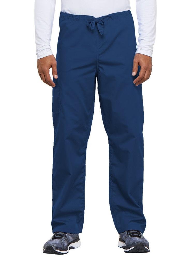 A young male Nurse Practitioner wearing a Cherokee Workwear Originals Unisex Drawstring Cargo Scrub Pant in Galaxy Blue size Medium Short featuring a total of 3 pockets.