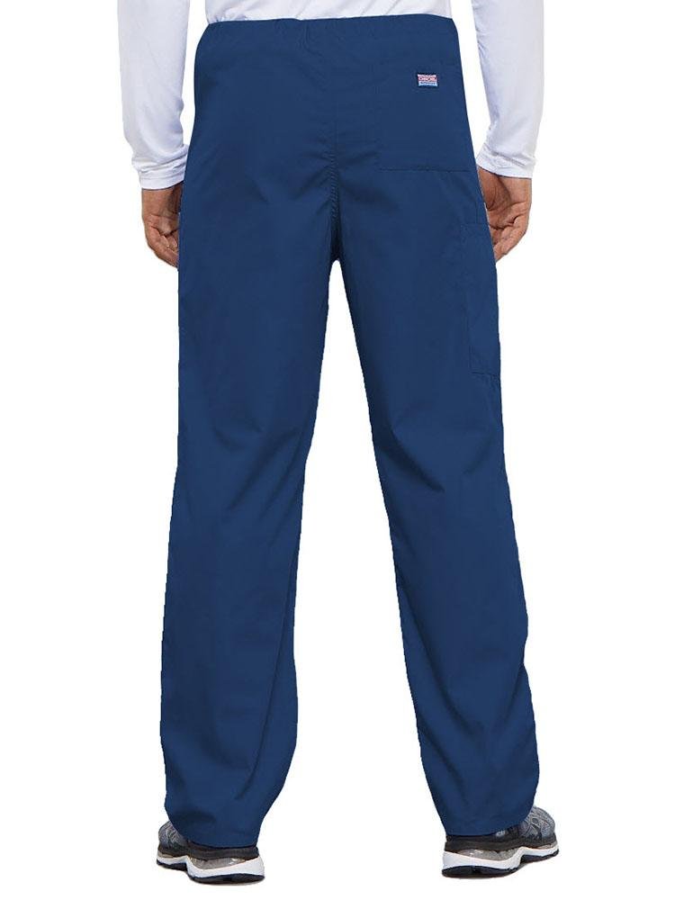 A young male Physical Therapist wearing a Cherokee Workwear Originals Unisex Drawstring Cargo Scrub Pant in Galaxy Blue  featuring 1 back pocket.