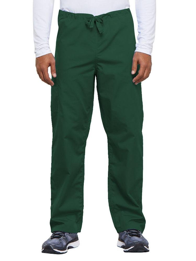A young male Nurse Practitioner wearing a Cherokee Workwear Originals Unisex Drawstring Cargo Scrub Pant in Hunter Green size Medium Short featuring a total of 3 pockets.