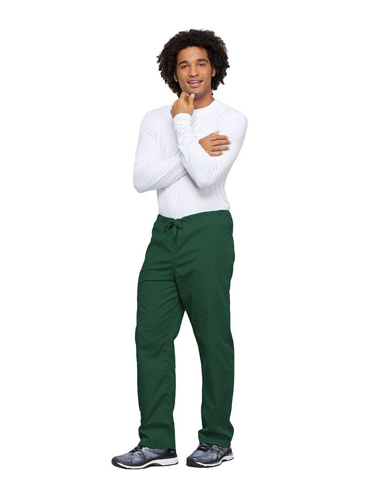 A young male Nurse wearing a Cherokee Workwear Unisex Drawstring Cargo Pant in Hunter Green size 4XL featuring an inseam of 31".