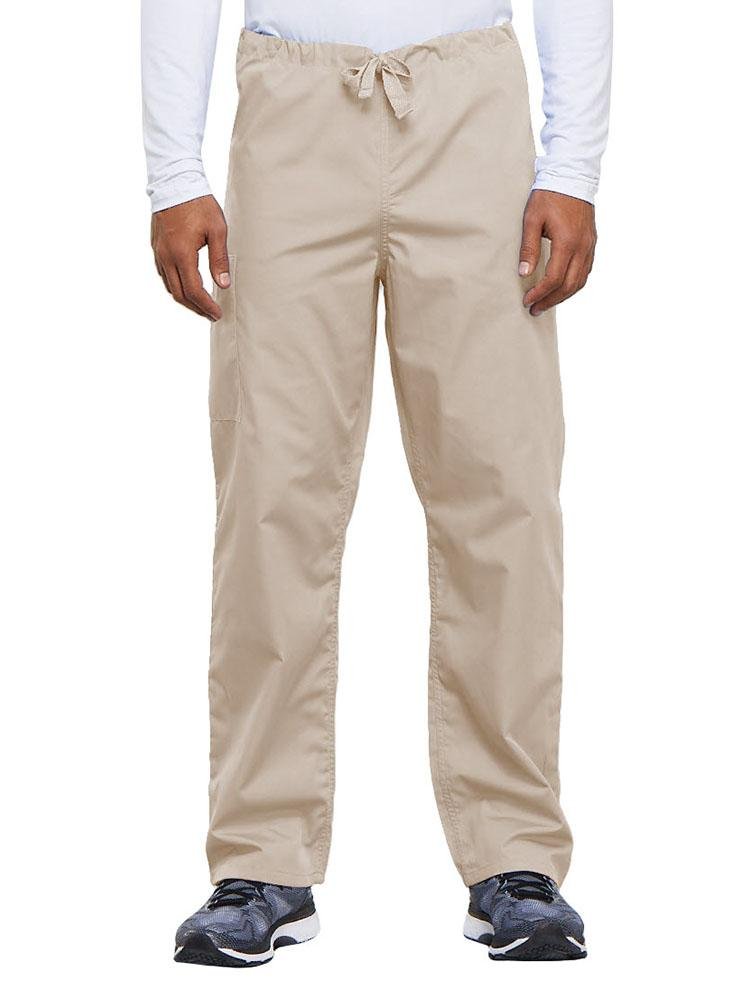 A young male Nurse Practitioner wearing a Cherokee Workwear Originals Unisex Drawstring Cargo Scrub Pant in Khaki size Medium Short featuring a total of 3 pockets.