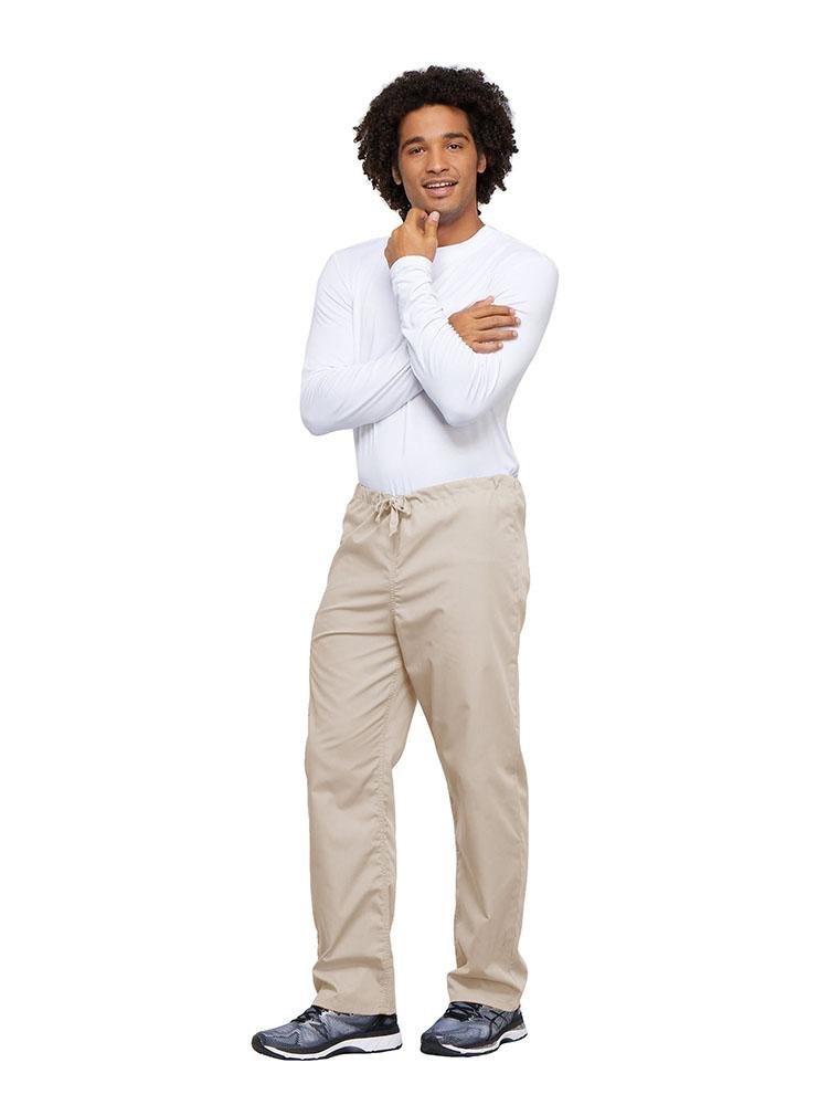 A young male Nurse wearing a Cherokee Workwear Unisex Drawstring Cargo Pant in Khaki size 4XL featuring an inseam of 31".