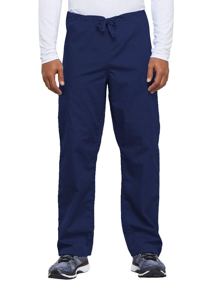 A young male Nurse Practitioner wearing a Cherokee Workwear Originals Unisex Drawstring Cargo Scrub Pant in Navy size Medium Short featuring a total of 3 pockets.