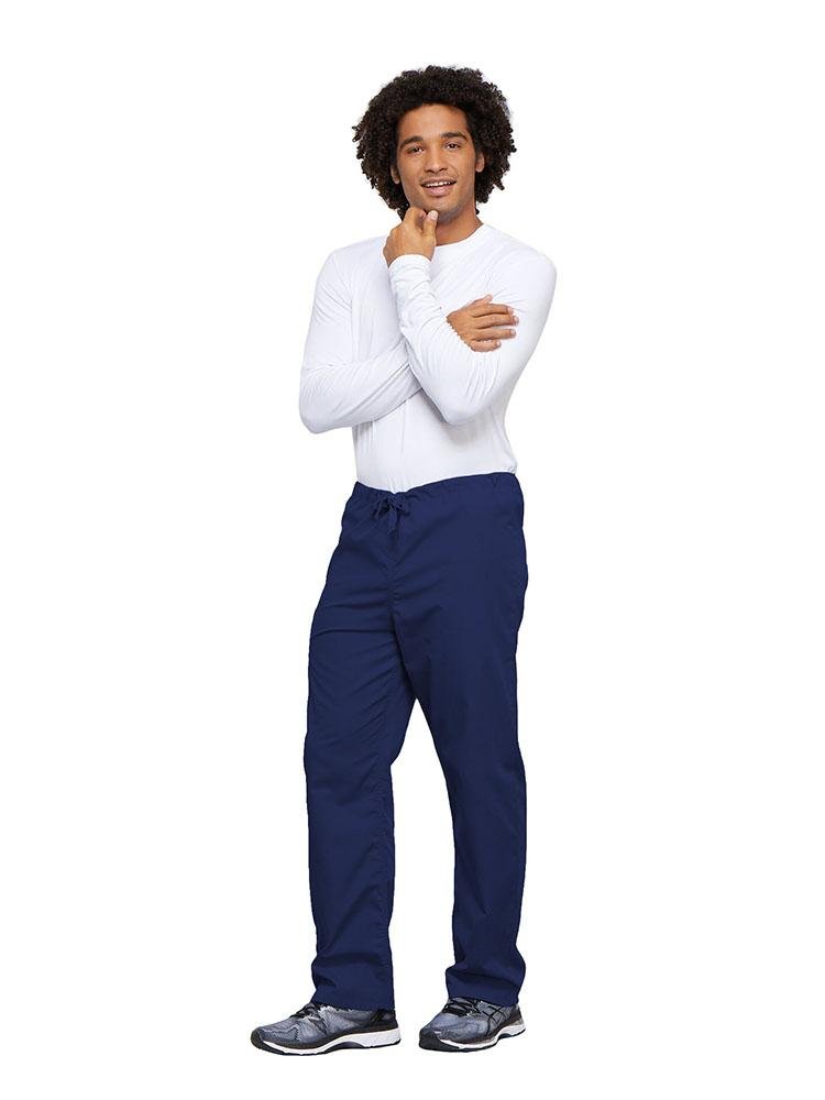 A young male Nurse wearing a Cherokee Workwear Unisex Drawstring Cargo Pant in Navy size 4XL featuring an inseam of 31".