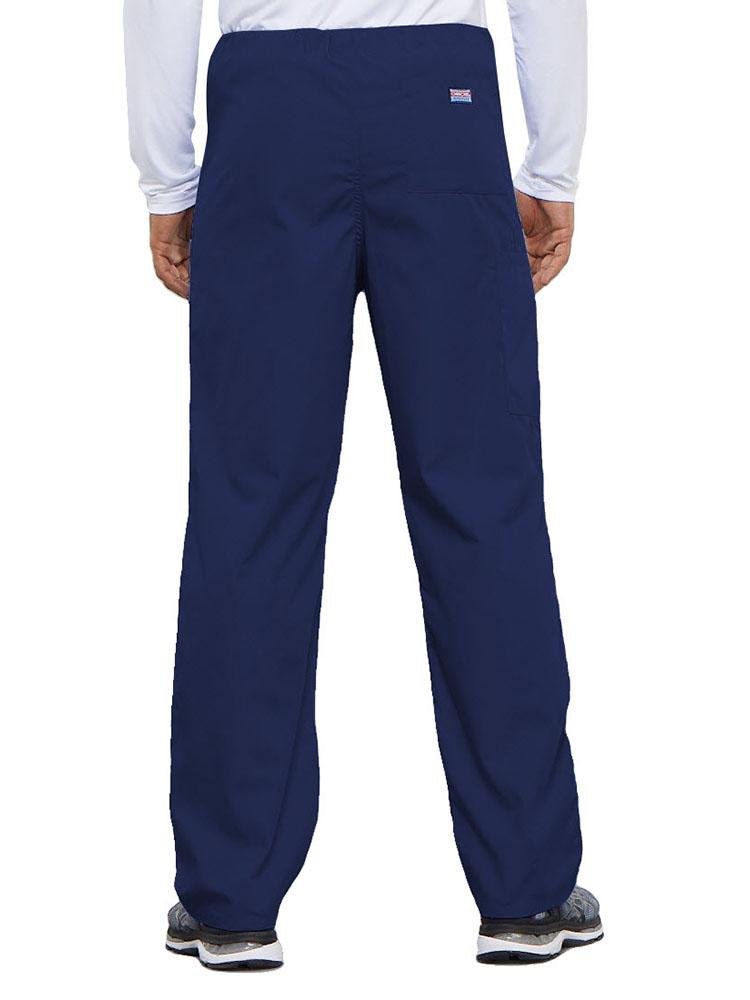 A young male Physical Therapist wearing a Cherokee Workwear Originals Unisex Drawstring Cargo Scrub Pant in Navy featuring 1 back pocket.