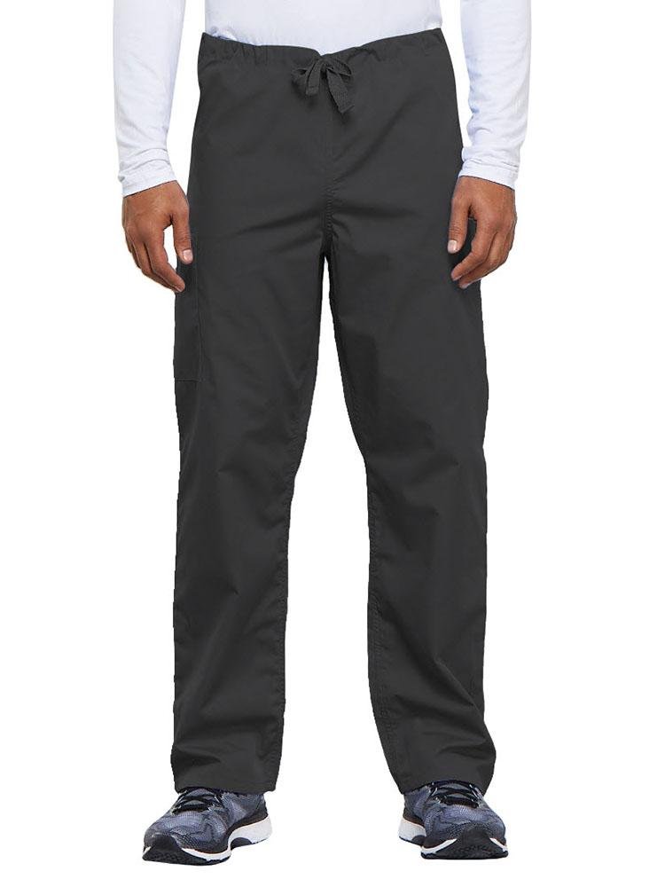A young male Nurse Practitioner wearing a Cherokee Workwear Originals Unisex Drawstring Cargo Scrub Pant in Pewter size Medium Short featuring a total of 3 pockets.