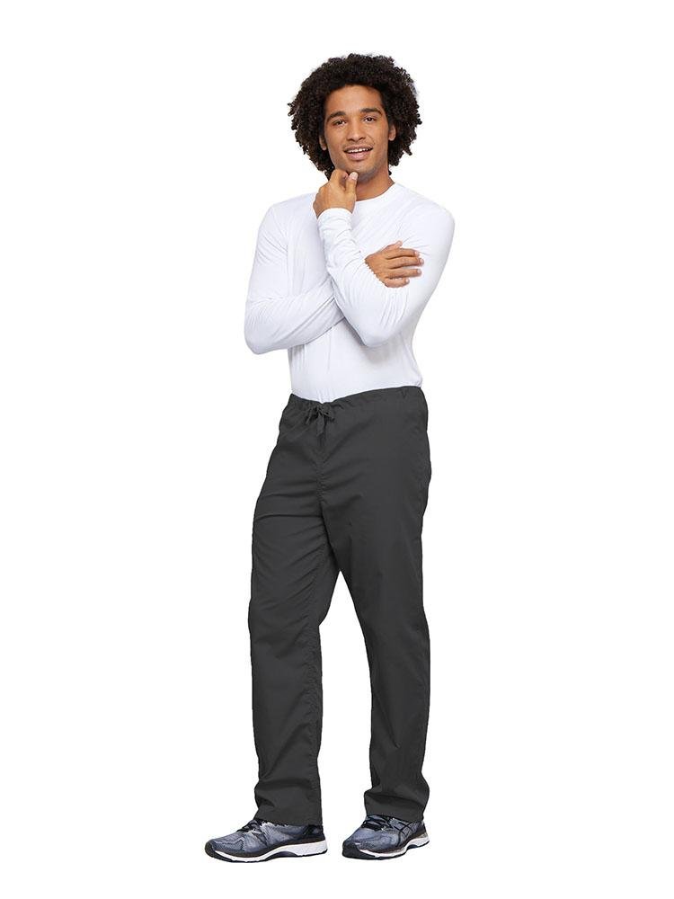 A young male Nurse wearing a Cherokee Workwear Unisex Drawstring Cargo Pant in Pewter size 4XL featuring an inseam of 31".