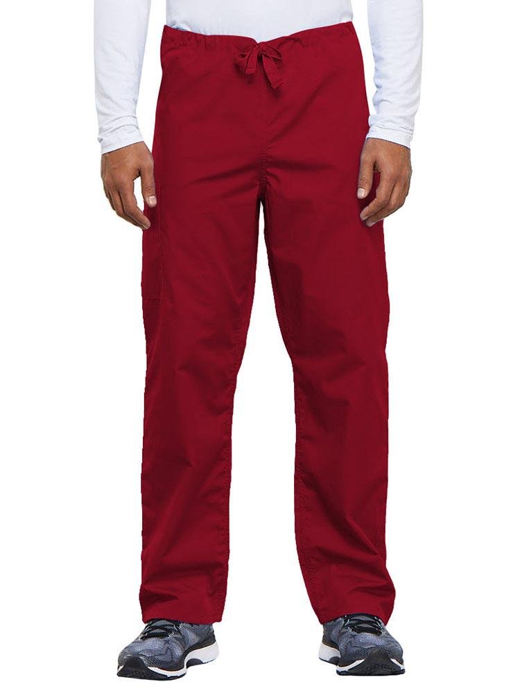 A young male Nurse Practitioner wearing a Cherokee Workwear Originals Unisex Drawstring Cargo Scrub Pant in Red size Medium Short featuring a total of 3 pockets.