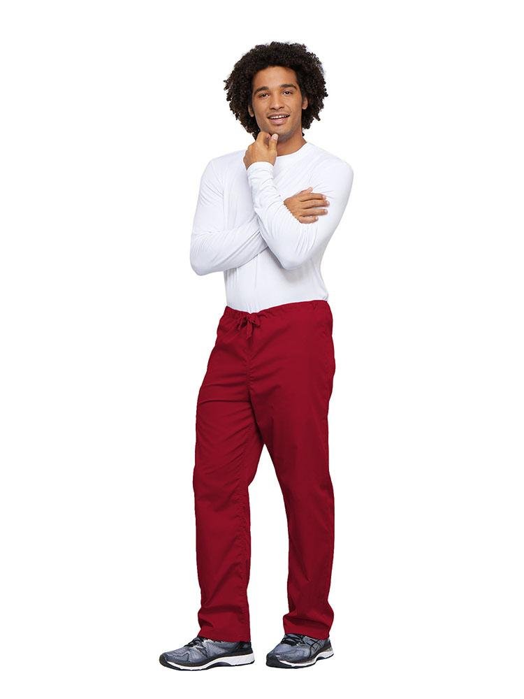 A young male Nurse wearing a Cherokee Workwear Unisex Drawstring Cargo Pant in Red size 4XL featuring an inseam of 31".