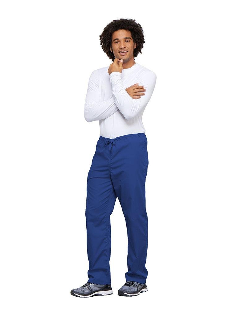 A young male Nurse wearing a Cherokee Workwear Unisex Drawstring Cargo Pant in Royal size 4XL featuring an inseam of 31".