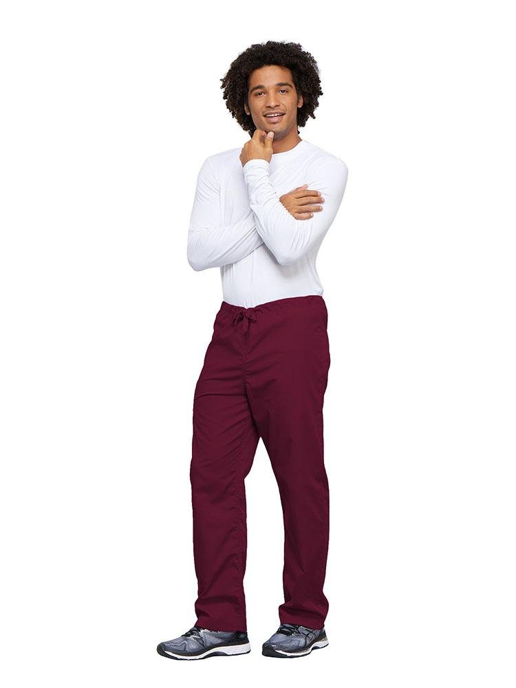 A young male Nurse wearing a Cherokee Workwear Unisex Drawstring Cargo Pant in Wine size 4XL featuring an inseam of 31".