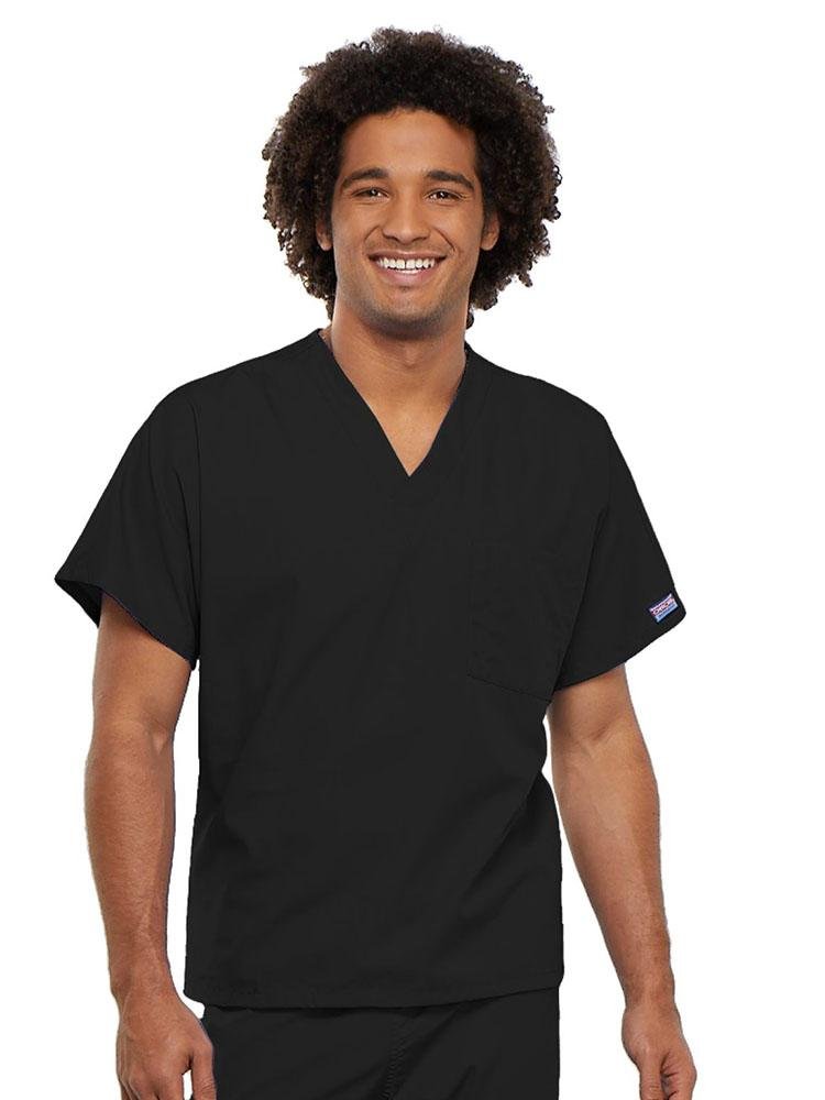 A young male Physician's Assistant wearing a Cherokee Workwear Originals Unisex Single Pocket V-neck Scrub Top in Black size 4XL featuring short sleeves.