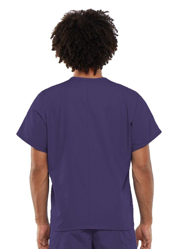 A young male Medical Assistant  wearing a Cherokee Workwear Originals Unisex Single Pocket V-neck Scrub Top in Grape size Large featuring a center back length of 27.5".