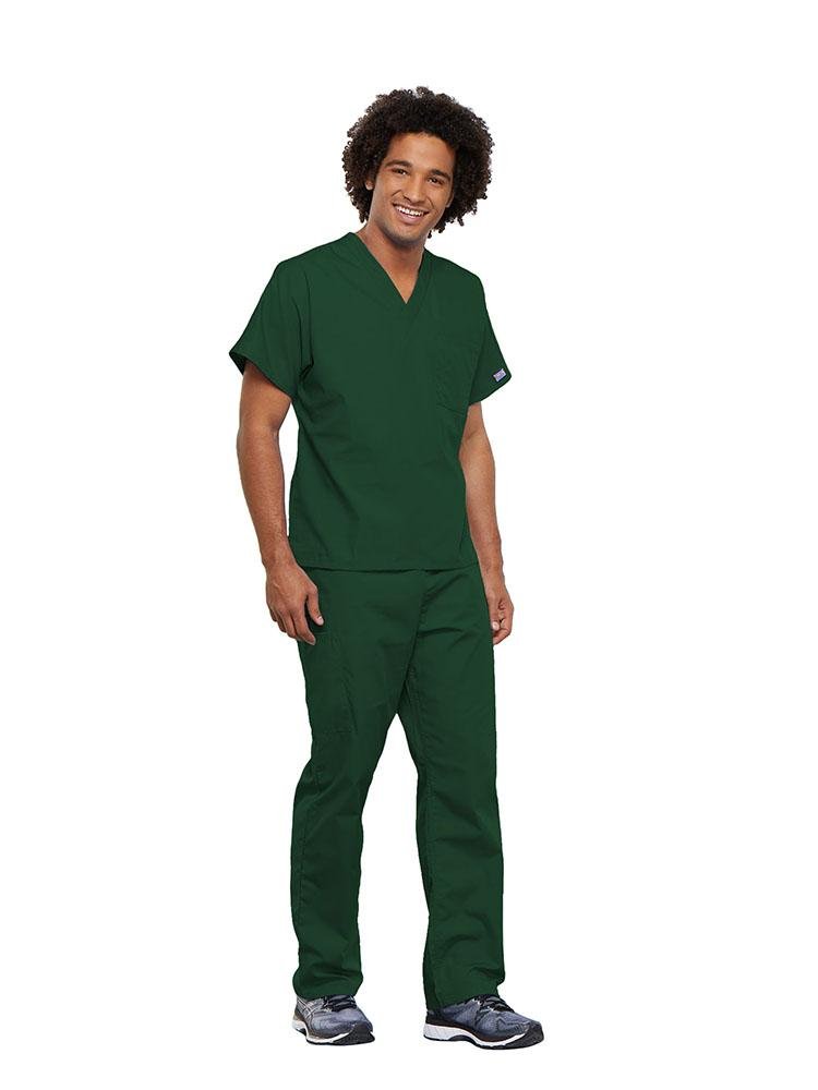 A male Physical Therapist wearing a Cherokee Workwear Originals unisex Single Pocket V-Neck Scrub Top in Hunter Green size 5XL featuring 1 spacious chest pocket.