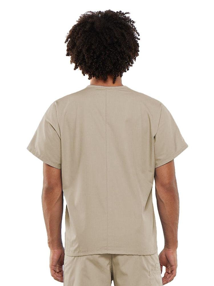 A young male Clinical Laboratory Technician wearing a Cherokee Workwear Originals Unisex Single Pocket V-neck Scrub Top in Khaki size Large featuring a center back length of 27.5".