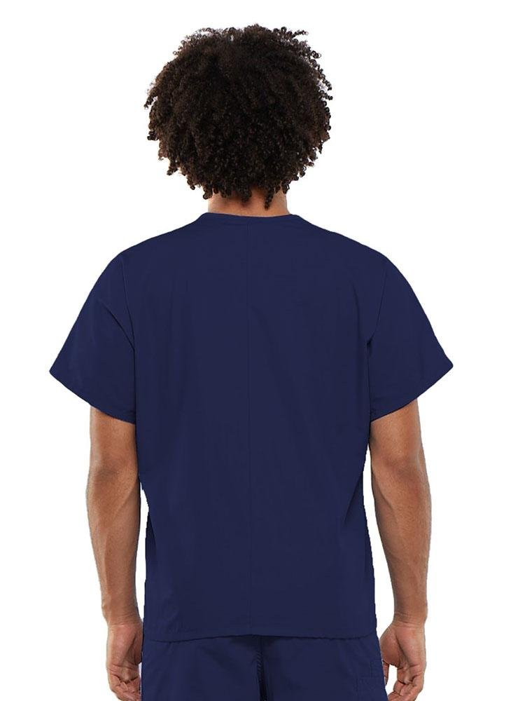 A young male Clinical Laboratory Technician wearing a Cherokee Workwear Originals Unisex Single Pocket V-neck Scrub Top in Navy size Large featuring a center back length of 27.5".