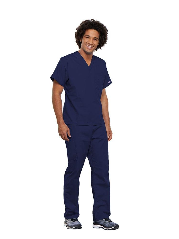 A male Occupational Therapist wearing a Cherokee Workwear Originals unisex Single Pocket V-Neck Scrub Top in Navy size 5XL featuring 1 spacious chest pocket.