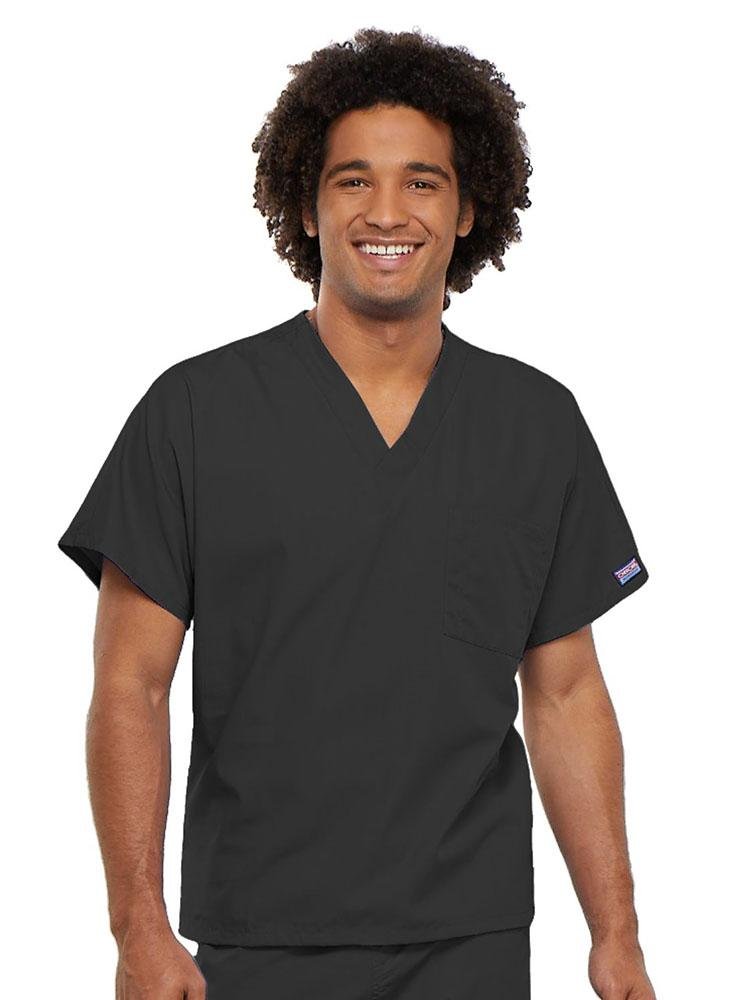 A young male Physician's Assistant wearing a Cherokee Workwear Originals Unisex Single Pocket V-neck Scrub Top in Pewter size 4XL featuring short sleeves.