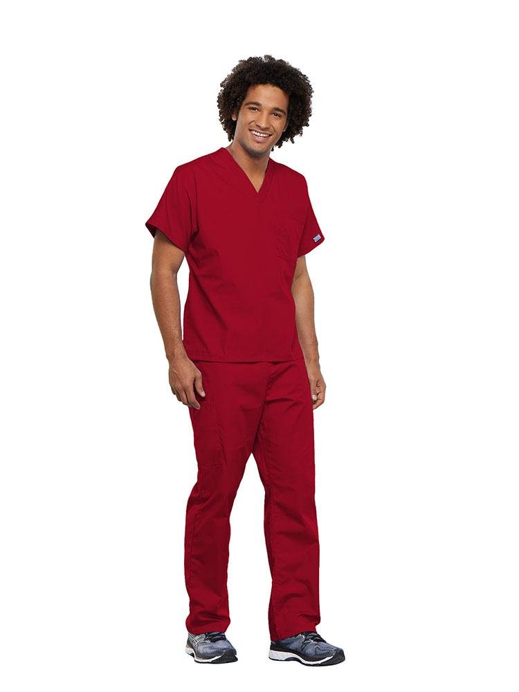 A male Surgical Technician wearing a Cherokee Workwear Originals unisex Single Pocket V-Neck Scrub Top in Red size 5XL featuring 1 spacious chest pocket.