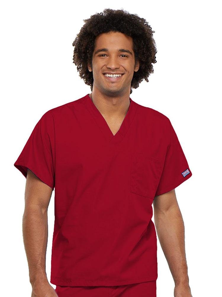 A young male Physician's Assistant wearing a Cherokee Workwear Originals Unisex Single Pocket V-neck Scrub Top in Red size 4XL featuring short sleeves.