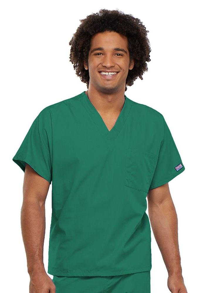 A young male Physician wearing a Cherokee Workwear Originals Unisex Single Pocket V-neck Scrub Top in Surgical Green size 4XL featuring short sleeves.